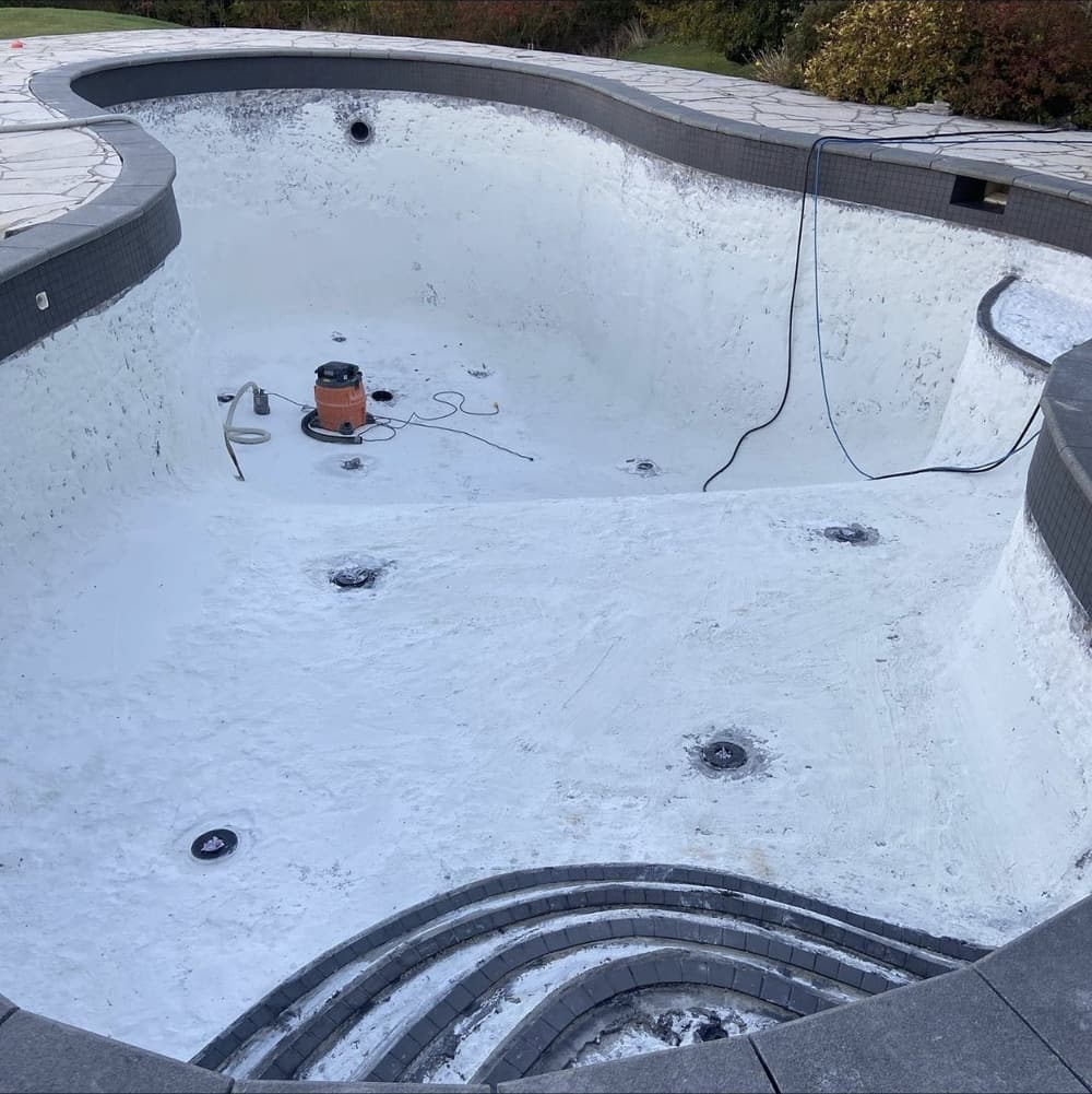 Pool with the old finish prepped and drains and fittings exposed