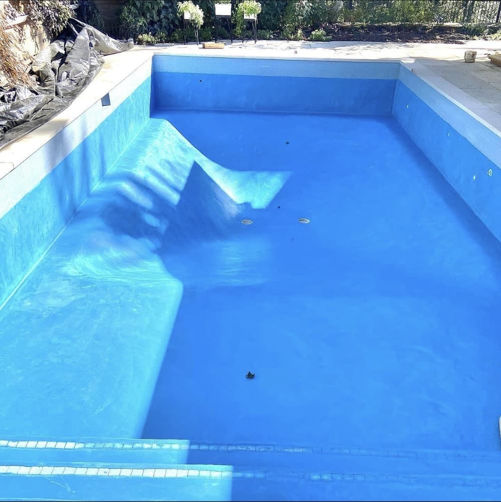 Rectangular pool with a new blue finish, ready to fill