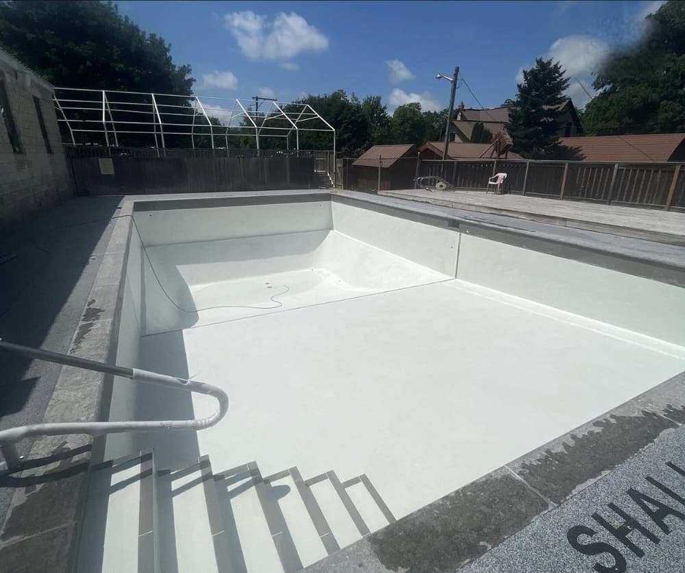 Rectangular pool with a fresh white marbelite finish before filling