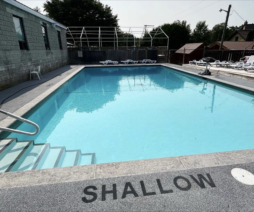 Resurfaced rectangular pool filled with clear blue water